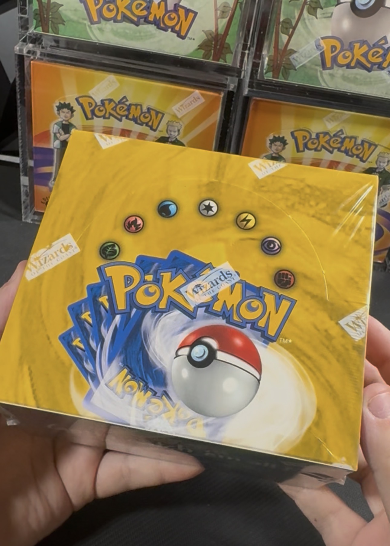 Vintage sealed Pokémon booster box held in hand